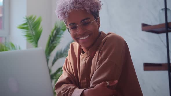 Overjoyed Young African American Woman Laughing and Looking at Camera alt