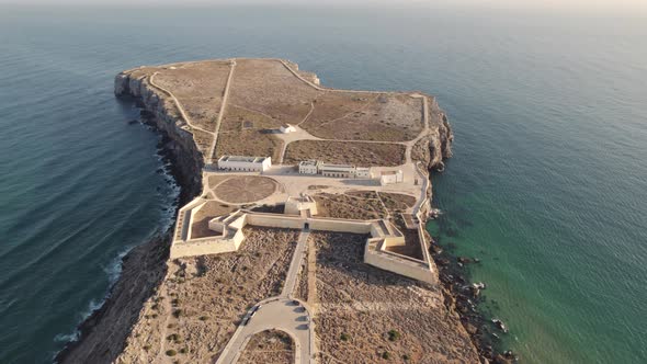 Fortress of Sagres, Portugal. Aerial orbit above peninsula with historical castle alt