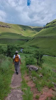 Young Woman Hiking in the Mountains of Drakensberg South Africa alt