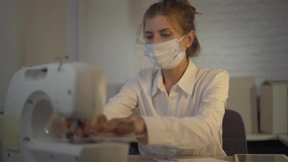 Portrait of Confident Seamstress Sewing Covid-19 Face Masks During Coronavirus Global Pandemic alt