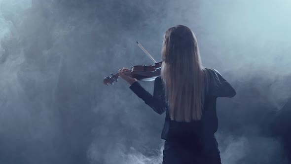 Young Beautiful Woman Playing a Melody on Violin, Smoky Dark Studio