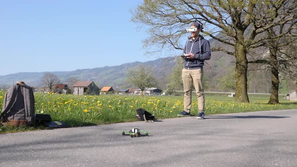 Caucasian man with vr goggles flying a fpv racing drone, slow motion wide shot alt