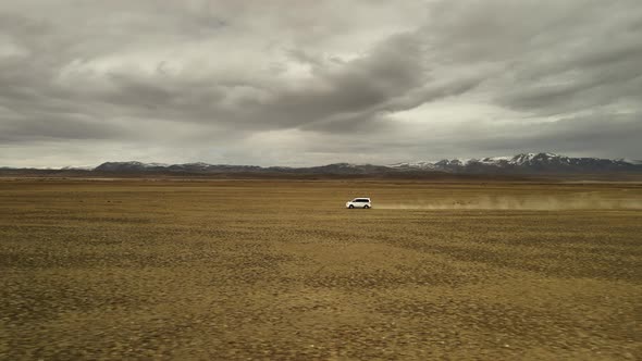 A White 4X4 Car Moves at High Speed Offroad alt