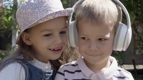 Portrait of Cute Little Two Children With Headphones Listening to Music