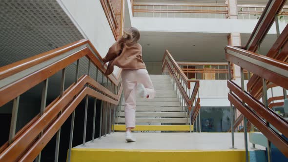 Young Woman Is Dancing On Stairs Near Balustrade