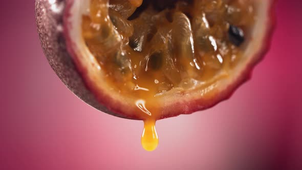 Slow Motion Macro Shot of Flowing Passion Fruit Maracuya Juice From Halved Maracuya alt