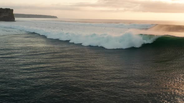 Following large waves at sunset