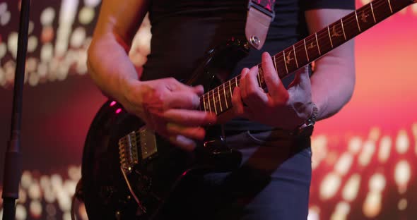 Man Plays an Electric Guitar alt