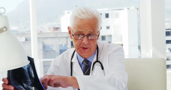Male doctor examining x-ray alt