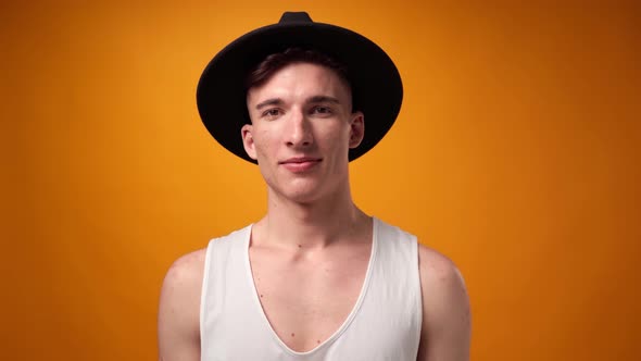 Young Casual Man Smiling Against Yellow Background