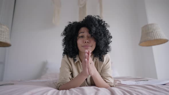 Young Woman Holding Hands Together Looking at Camera alt