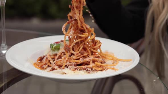 Close-up Attractive Female Hand Eating Tasty Fresh Pasta From White Big Plate Using Fork