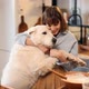 Woman Playing with Her Huge Dog While Cooking at Home - VideoHive Item for Sale