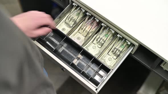 Top view of the opening department with dollars in cash at the store checkout alt