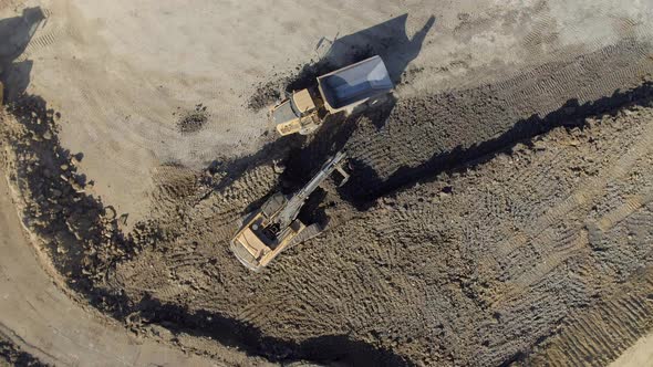 Digger Filling a Lorry With Soil and Mud During Groundworks alt
