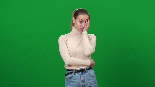 Portrait of Young Shocked Woman Holding Face with Hand Looking at Camera alt