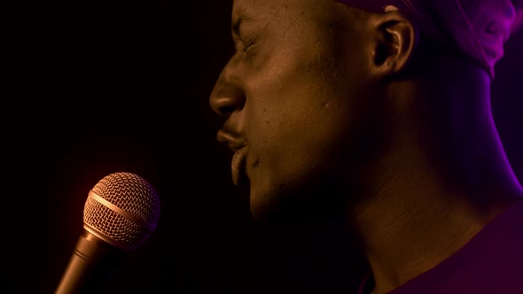 Emotional Black Singer Guy Singing Near Microphone In Dark Studio alt