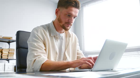 Concentrated businessman signs contract online alt