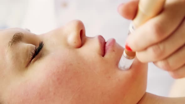 Beautician cosmetologist doing procedure fractional microneedle mesotherapy alt