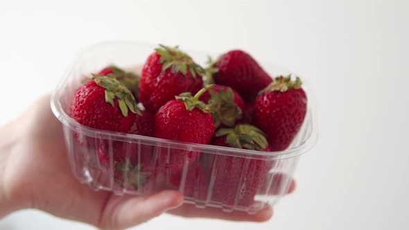 Transparent Plastic Box with Fresh Strawberries on a White Background
