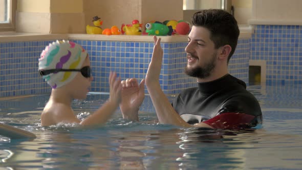 Rehabilitation Centre Evexia, swimming lesson, small boy and teacher in swimming pool alt