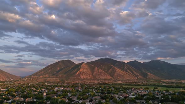 Flying towards the mountains over Spanish Fork City, Utah alt
