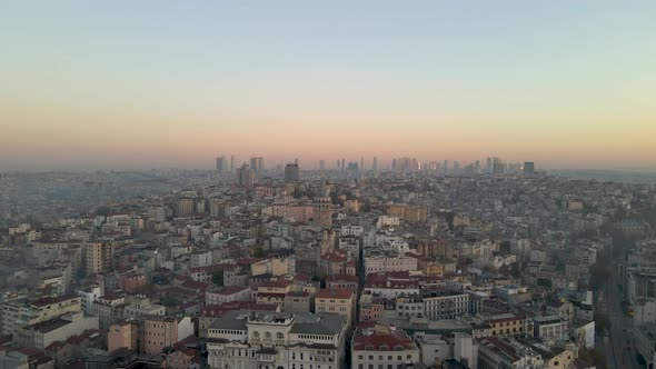 Aerial shot Galata. Flying forward to Galata Tower at Sunrise over old buildings.