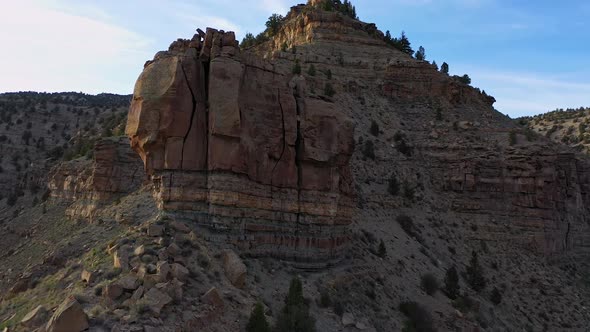 Flying up along ridge of rock desert terrain in Nine Mile Canyon alt