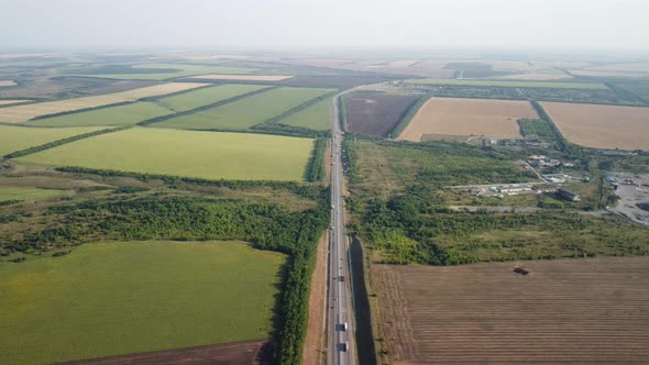 a Highway Stretching to the Horizon Among Agricultural Fields