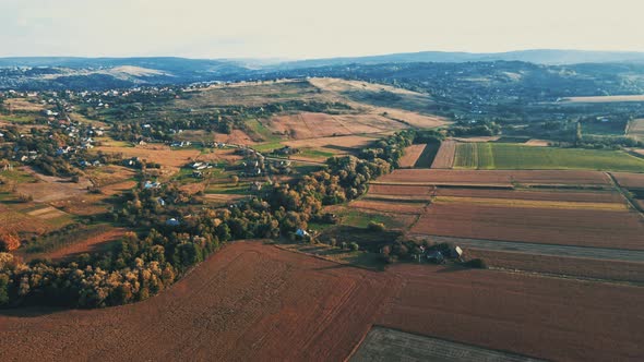 Ukrainian fields stretch on the hills near the settlements Aerial view