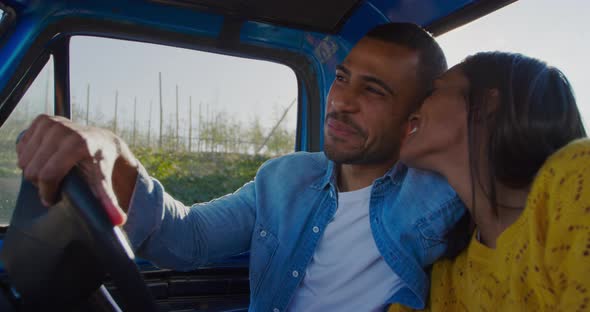 Young couple on a road trip in their pick-up truck alt