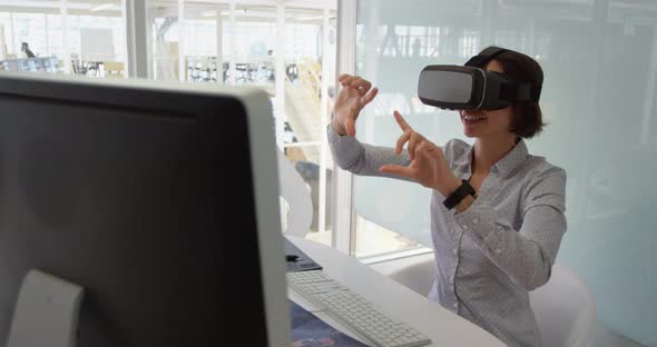 Businesswoman using virtual reality headset at desk in modern office 4 4k