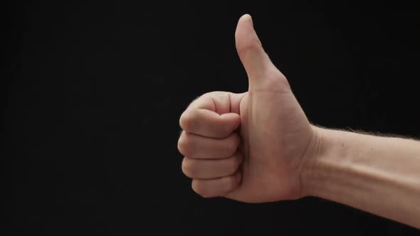 Man Hand Show Thumbs Up Gesture on Black Background alt