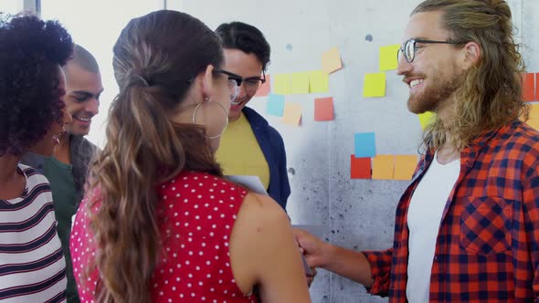 Happy colleagues interacting with each other 4k alt