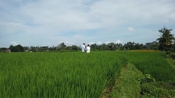 Beautiful family couple looking on rice terraces, Bali, Indonesia. Romantic love story on nature