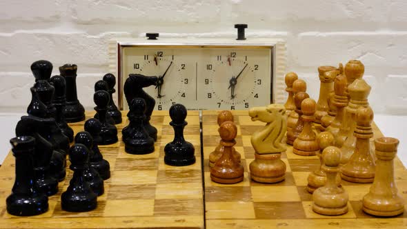 Chessboard with the Queen Gambit opening and a clock showing the time