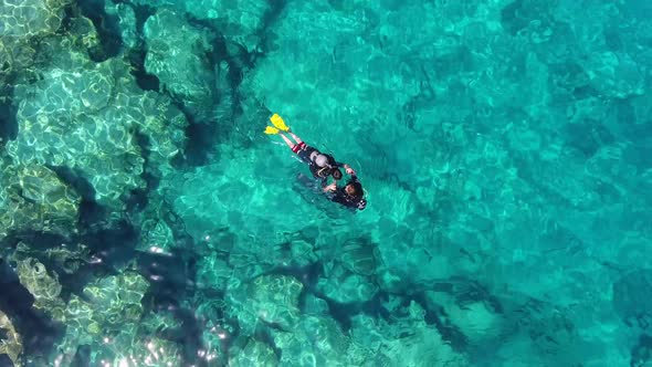 Aerial View of Divers Swimming Underwater Sea alt
