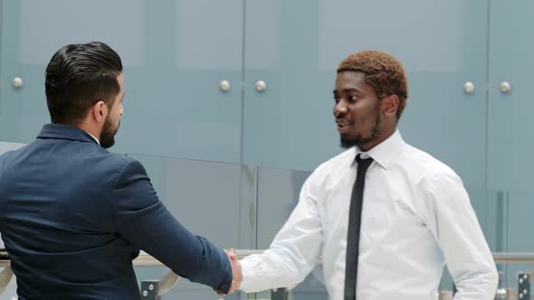 African American businessman shaking hands his colleague indoor