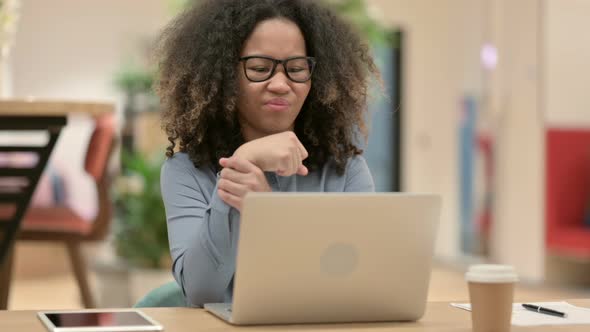 Young African Woman with Laptop Having Wrist Pain alt