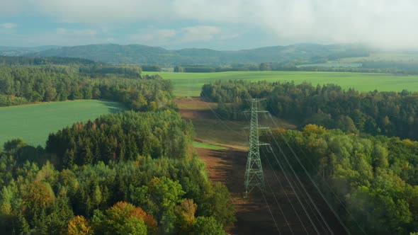 Flight Along High Voltage Power Lines and High Voltage Electric Transmission Tower or Pylon on the alt