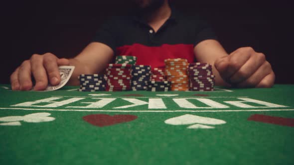 Male Player Betting All Chips in While Playing in Casino Close Up