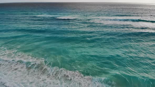 An Aerial View of Waves Crashing on Beach in Cancun alt