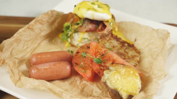Delicious Breakfast with Red Tomatoes Potatoes Sausage and Poached Egg on a Plate alt