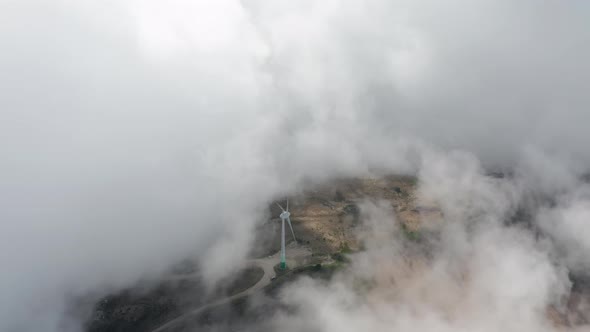 White Clouds Moving in Sky Over Wind Turbine alt