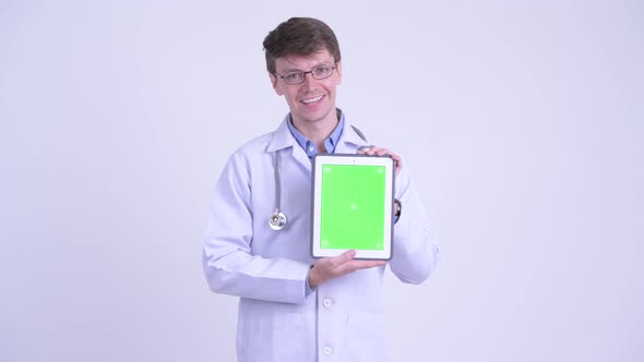 Happy Young Man Doctor Talking While Showing Digital Tablet alt