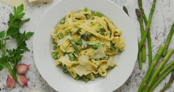 Homemade Tagliatelle Pasta with Creamy Ricotta Cheese Sauce and Asparagus Served White Ceramic Plate alt