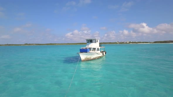 Aerial drone view of a fishing motor boat in the Bahamas, Caribbean.  alt
