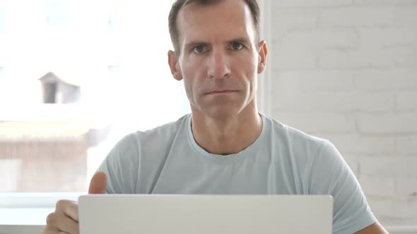 Thumbs Down By Man at Work alt