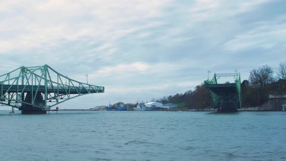 Timelapse of closing Oskara Kalpaka swing bridge in Liepaja in cloudy autumn day, wide shot alt