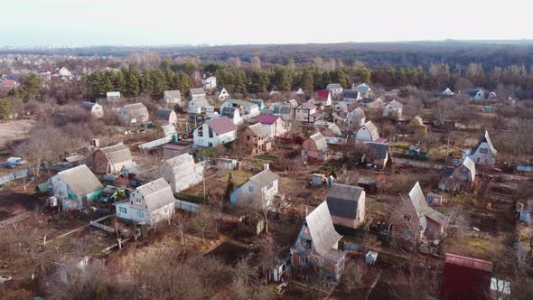 Aerial Drone View Flight Over Small Brick Houses with Plot of Land in the Middle alt